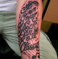 Text and music notes tattoo by Ian The Comedian